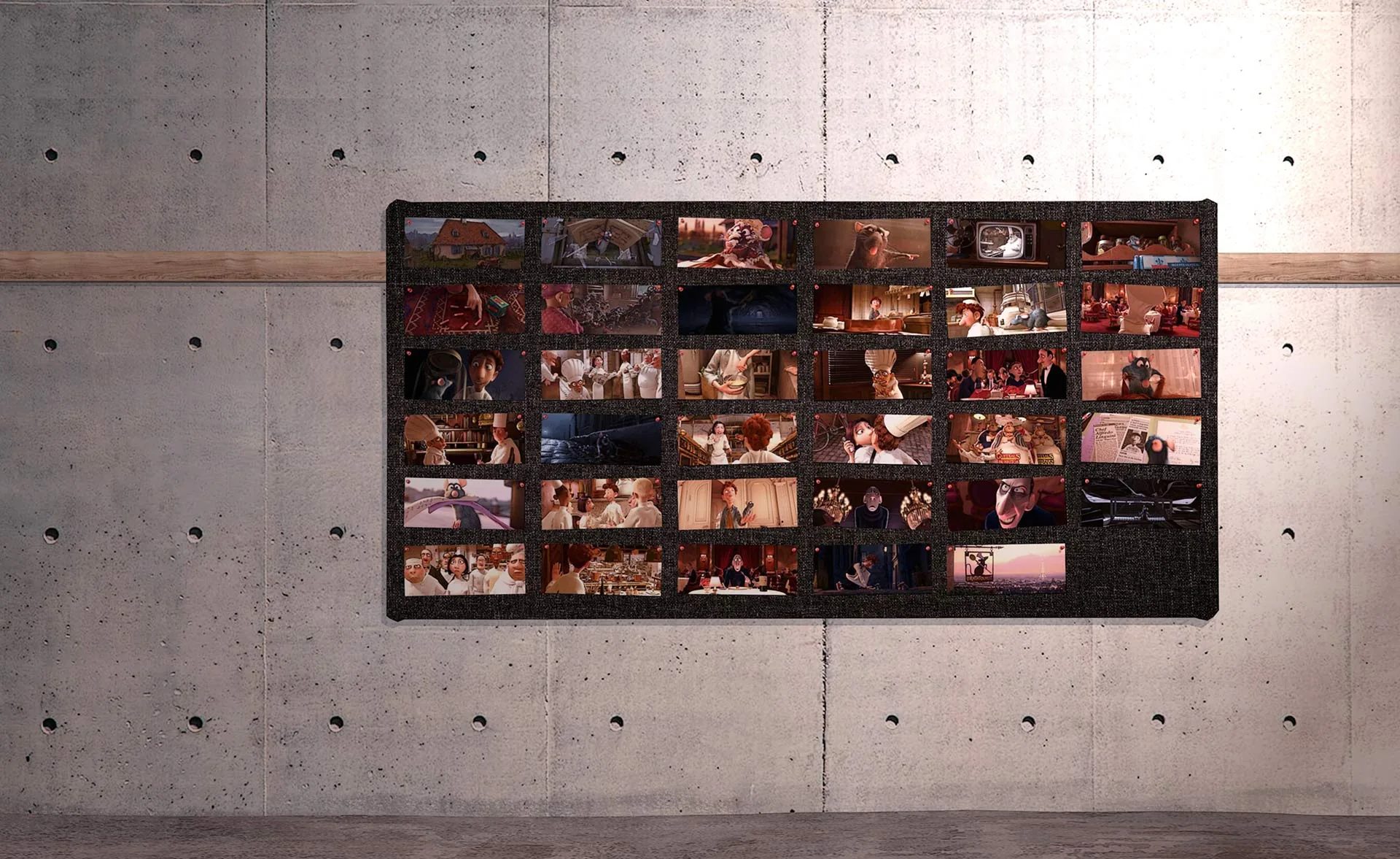 A grid of storyboard frames pinned to a large movable board, mounted on a concrete wall